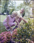 Couple Smiles and Tends to Garden in Beverly Hills, Florida, B by Skip Gandy