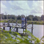 Older Man in Straw Hat Teaches Child to Fish in Beverly Hills, Florida, C by Skip Gandy