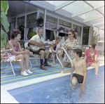 Adults Mingle and Play Guitar Poolside in Beverly Hills, Florida, A