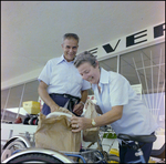 Couple Loads Charcoal Onto Bicycle in Beverly Hills, Florida, E by Skip Gandy