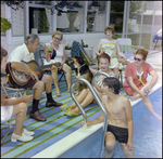 Adults Mingle and Play Guitar Poolside in Beverly Hills, Florida, D