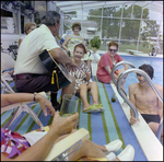 Adults Mingle and Play Guitar Poolside in Beverly Hills, Florida, G