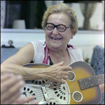 Woman Plays Guitar Poolside in Beverly Hills, Florida, D by Skip Gandy