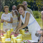 Woman Smiles While Cutting Watermelon in Beverly Hills, Florida by Skip Gandy