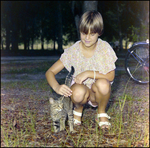 Young Girl Pets a Cat in Beverly Hills, Florida by Skip Gandy