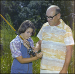 Man Instructs Child on Using Fishing Rod in Beverly Hills, Florida, A by Skip Gandy