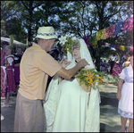 Man Helps Bride With Her Veil at German American Social Club Festival in Beverly Hills, Florida by Skip Gandy