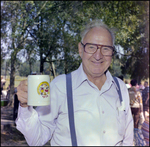 Man Holds Mug From Bavarian Summer Festival at German American Social Club Event in Beverly Hills, Florida by Skip Gandy