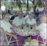 Four Attendees Smile Around Folding Table at German American Social Club Festival in Beverly Hills, Florida, B by Skip Gandy