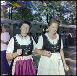 Two Women Link Arms and Hands at German American Social Club Festival in Beverly Hills, Florida by Skip Gandy