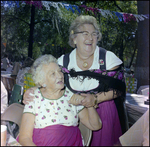 Woman Holds Friend's Shoulders at German American Social Club Festival in Beverly Hills, Florida by Skip Gandy