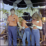 Three People Stand Behind Microphone at Burnt Store Marina Seafood Festival in Punta Gorda, Florida by Skip Gandy