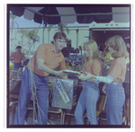 Man Passes Clipboard to Two Peers at Burnt Store Marina Seafood Festival in Punta Gorda, Florida by Skip Gandy