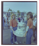 Two Women Hold Tiered Cake at Burnt Store Marina Seafood Festival in Punta Gorda, Florida, B by Skip Gandy