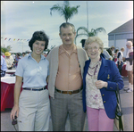 Two Women Stand Beside Man for Picture at Burnt Store Marina Seafood Festival in Punta Gorda, Florida by Skip Gandy