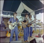 Two Guitarists and a Bass Player Sing Onstage at Burnt Store Marina Seafood Festival in Punta Gorda, Florida by Skip Gandy