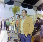 Man in Corduroy Jacket Addresses Crowd at Burnt Store Marina Seafood Festival in Punta Gorda, Florida, A by Skip Gandy