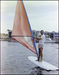 Windsurfer Stands on Sailboard in Water at Burnt Store Marina Seafood Festival in Punta Gorda, Florida by Skip Gandy