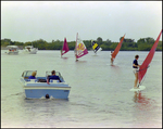 Windsurfers Sail Beside Boat at Burnt Store Marina Seafood Festival in Punta Gorda, Florida, B by Skip Gandy