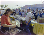 Staff Members Serve Food at Burnt Store Marina Seafood Festival in Punta Gorda, Florida, B by Skip Gandy