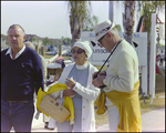 Couple in Matching Yellow Outfits Pause While Browsing at Burnt Store Marina Seafood Festival in Punta Gorda, Florida by Skip Gandy