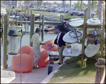 Men Chat Beside Large Buoys at Burnt Store Marina Seafood Festival in Punta Gorda, Florida by Skip Gandy