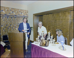 Man at Podium Near Table of Trophies, Burnt Store Marina Seafood Festival, Punta Gorda, Florida, A by Skip Gandy