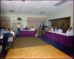 Man Speaking at Podium to Attendees, Burnt Store Marina Seafood Festival, Punta Gorda, Florida by Skip Gandy