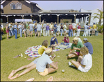 Group of People Relaxing on Lawn As People Wait in Line for Food Behind Them, Burnt Store Marina Seafood Festival, Punta Gorda, Florida by Skip Gandy