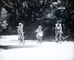 Family Riding Bicycles on a Rural Street, Tampa, Florida, A by George Skip Gandy IV