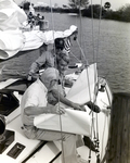 Three Men on a Sailboat Looking at Maps, Tampa, Florida, A by George Skip Gandy IV