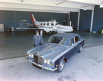 Chauffeur with Rolls Royce Silver Shadow and Piper Navajo Private Plane in Hangar, Tampa, Florida, A by George Skip Gandy IV