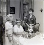 Mrs. Eliot Fletcher and Mrs. Leland Carlton Talking Over Tea Set at Community Concert Association Birthday Event, Tampa, Florida, A by George Skip Gandy IV