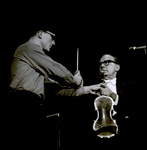 Jack Benny Handing Off Violin Onstage, Tampa, Florida by George Skip Gandy IV