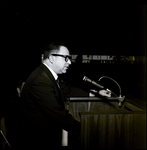 Man Speaking into Microphone at Podium, Tampa, Florida by George Skip Gandy IV