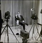 Man Holding Cigar and Flag in Front of Cameras, Tampa, Florida by George Skip Gandy IV