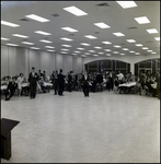 People Sitting at Banquet Tables and Walking Around, Tampa, Florida by George Skip Gandy IV