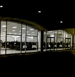 People Sitting at Long Banquet Tables Through a Window, Tampa, Florida by George Skip Gandy IV