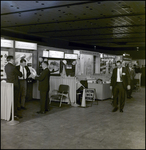 Men Talking and Walking in Front of Construction and Safety Exhibits, Tampa, Florida by George Skip Gandy IV