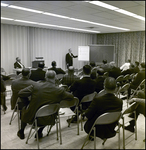 Sitting Crowd Watching Man Speak Next to Whiteboard, Tampa, Florida, B by George Skip Gandy IV