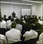 Sitting Crowd Watching Man Speak at Podium, Tampa, Florida, E by George Skip Gandy IV