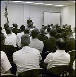 Sitting Crowd Watching Man Speak at Podium, Tampa, Florida, F by George Skip Gandy IV