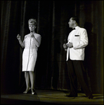 Man and Woman Speaking into Microphones Onstage, Tampa, Florida by George Skip Gandy IV