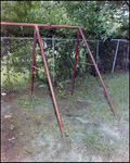 Empty Metal Swing Set Near Fence, Tampa, Florida, B by George Skip Gandy IV