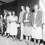 Two Flight Attendants Pose with Businessman and Others by George Skip Gandy IV