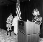 Woman Makes a Speech from Behind a Podium by George Skip Gandy IV