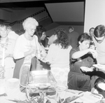 Party-Goers Serving Food from a Chafing Dish Buffet, A by George Skip Gandy IV