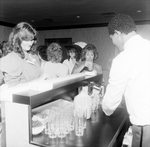 Partygoers Get Drinks from a Bartender by George Skip Gandy IV