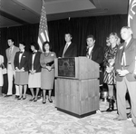 Speakers and Staff Behind a Podium at the Harbour Island Hotel, B by George Skip Gandy IV