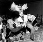 A Dancer in White Makeup Grins at the Camera Next to a Man Dressed as a Pirate